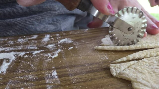 cutting fresh pasta flour dough in daylight