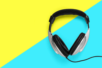 grey headphone with black sponge and finishing on yellow and cyan color block with copy space for...