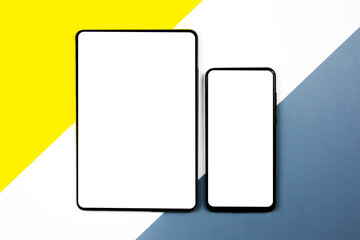 Mock up of a smartphone and a tablet on different colored backgrounds.