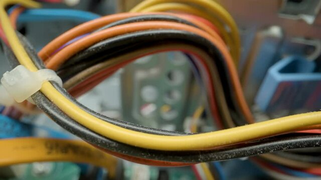 The different colors of electric wires connected on the CPU of the computer