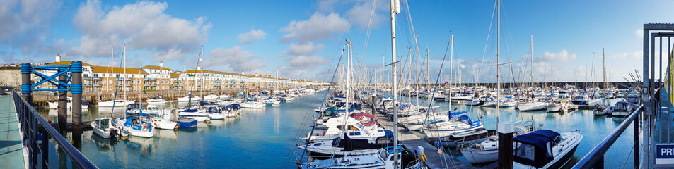 Fototapeta na wymiar Brighton Marina section with a lines group of selling boat at East Susex Brighton, UK.