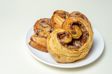 Obraz na płótnie Canvas French sweet bun. On a white plate High quality photo
