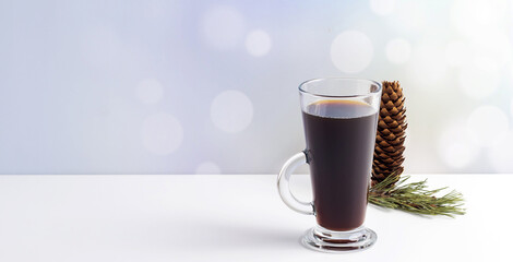 Hot coffe with marshmallows in transparent tall glass, isolated on white background.