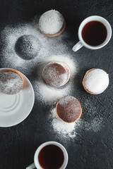 Fresh pastries, pastries from the bakery with white cups of coffee on a dark background