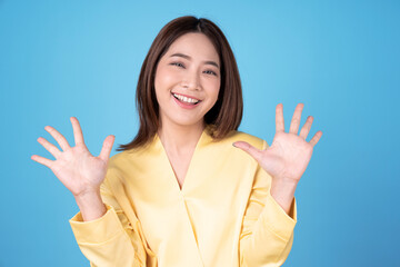 Asian women are in a good mood and are happy, Isolated on a blue background.