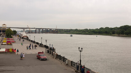  People walking along the waterfront, fishermen catch fish