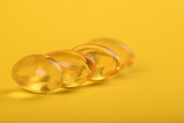 Yellow pills, yellow background. Assorted pharmaceutical medicine pills, tablets and capsules over yellow background. High resolution image for pharmaceutical industry.