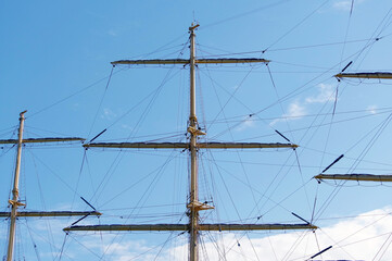 Masts and rigging of a sailing ship against sky