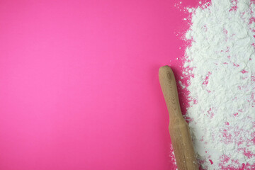 Baking background with copy space on a pink surface for your text. View from above. Flour is a traditional ingredient in bread and other baked goods. Often used in Italian, Russian, Arabic and Chinese