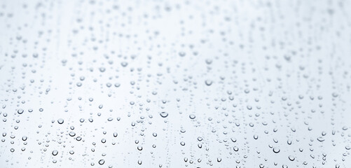Naklejka na ściany i meble Water drops are on glass, background photo