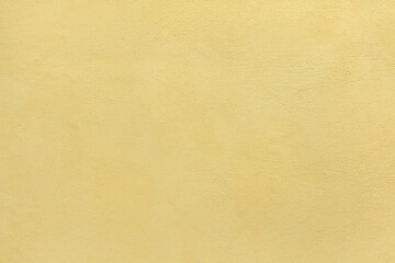 Yellow painted stucco wall. Background texture
