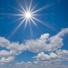 Naklejka na ściany i meble sparkle sun on the blue cloudy sky background