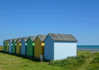 Fototapeta na wymiar multi coloured beach huts at the seaside