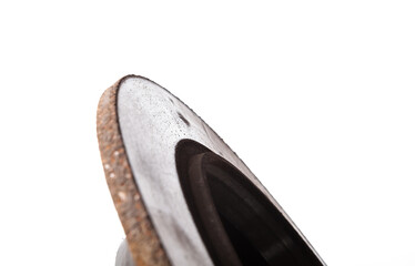 Old brake discs covered with rust on a white isolated background in a photography studio. Seasonal repair of suspension and brake system in workshop or sale of spare parts for auto analysis.