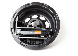 Spare wheel replacement kit on a white background in a photo studio with a jack and a wrench for...