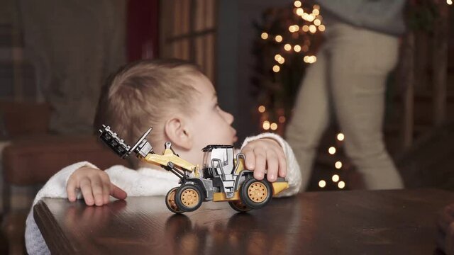 Child boy with toy tractor