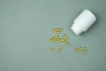 Fish oil tablets. Omega-3 gel capsules. Healthy omega-3 pills. Food supplement derived from cod liver. Healthcare and medical concept. 