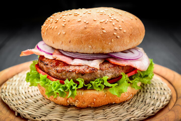 Bacon burger with beef cutlet on wooden background