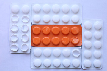 Orange packaging of vitamin C tablets, and others white packaging with tablets for the treatment of...