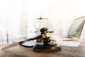 Justice and law concept.Male judge in a courtroom with the gavel, working with, computer and...