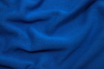 Naklejka na ściany i meble Pleats on fabric, knitted material of bright blue color, folds