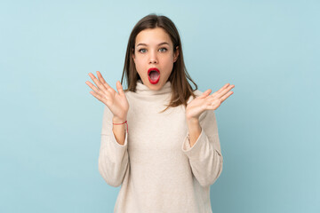Teenager girl isolated on blue background with surprise facial expression