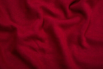 Pleats on fabric, knitted material of Crimson color, folds