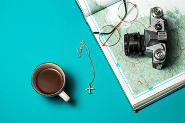 Plan your vacation. Travel preparation basics. World map, coffee cup, vintage film camera on a...