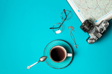 Plan your vacation. Travel preparation basics. World map, coffee cup, vintage film camera on a...