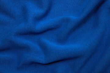 Fototapeta na wymiar Pleats on fabric, knitted material of khaki color, folds
