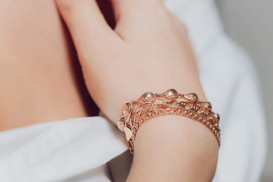 close up of boho styled woman hands with silver jewelry.