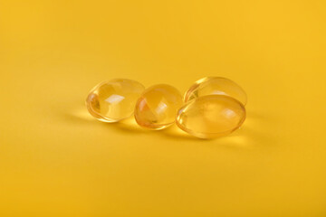 Yellow pills, yellow background. Assorted pharmaceutical medicine pills, tablets and capsules over yellow background. High resolution image for pharmaceutical industry.