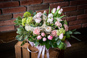 Fototapeta na wymiar Bouquet of fresh delicate flowers on a dark shady blured background gift