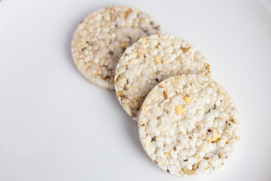 Three rice bread on a large white glossy background. Vegan healthy food