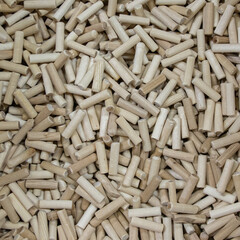 lots of wooden dowels for furniture production background image without people close up