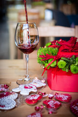 The wine is poured into a glass. Red bouquet for Valentine's Day