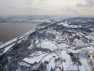 View of the Dnieper and the snow-covered right bank of Kiev. Aerial drone view. Winter snowy morning.