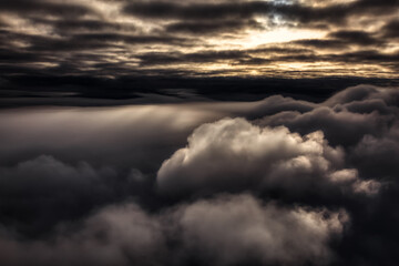 Cloudscape Background. Beautiful and striking aerial view of the puffy clouds. Dramatic Dark Art...