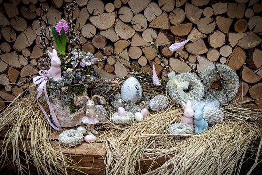 Easter bouquet composition with colorful eggs in nest on wooden background. Angement flower eco with copy space