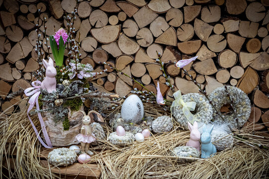 Easter bouquet composition with colorful eggs in nest on wooden background. Angement flower eco with copy space