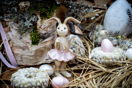 Easter bouquet composition with colorful eggs in nest on wooden background. Angement flower eco with copy space