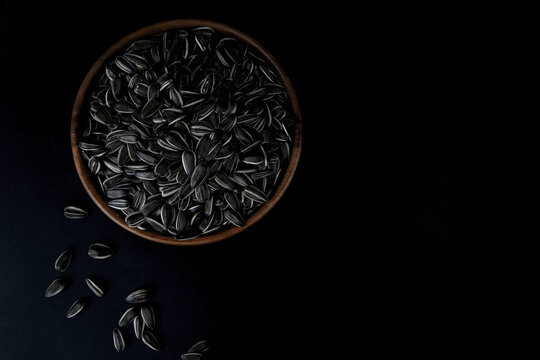 Sunflower seeds in a wooden plate. Healthy food concept.
