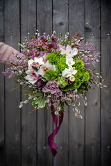 Bouquet of fresh delicate flowers on a dark shady blured background gift