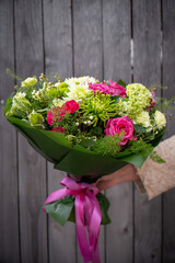 Bouquet of fresh delicate flowers on a dark shady blured background gift