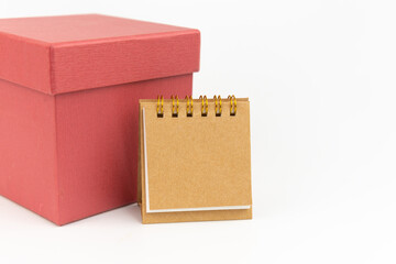 Notepad or calendar with gift box on white background. Gift  Concept. Copy Space.