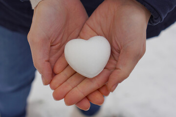 Heart snowball in woman´s hands