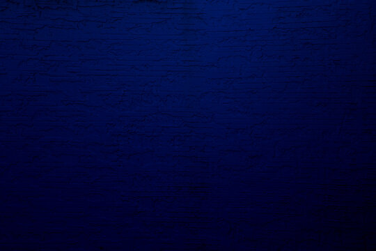 texture of a dark blue wall covered with volumetric plaster, space for text, space for copy