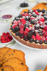 Delicious raspberry  tart (tartlet) with whipped cream. Breakfast Buffet Concept, Breakfast Time. Various brunch on the table