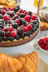 Delicious raspberry  tart (tartlet) with whipped cream. Breakfast Buffet Concept, Breakfast Time. Various brunch on the table