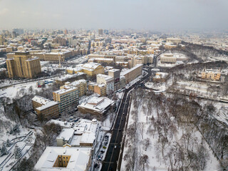 Kiev covered with snow. Aerial drone view. Frosty winter cloudy morning.